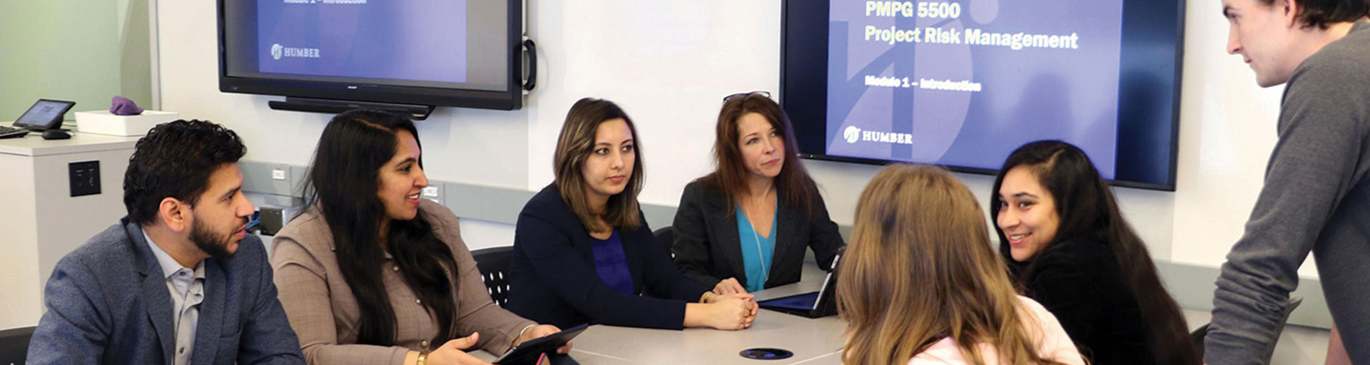 group of people sitting around a table have a discussion