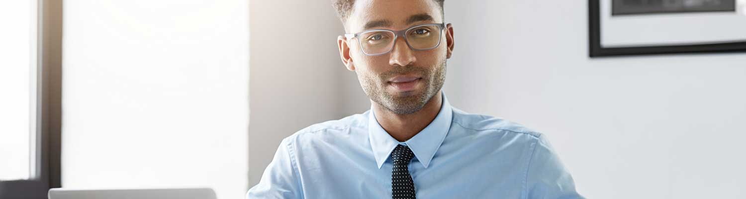 person dressed in business clothing smiling