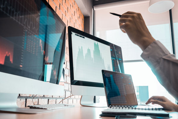 Hand pointing at computer monitor