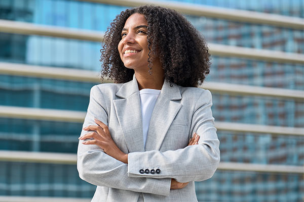 business person standing in city looking away