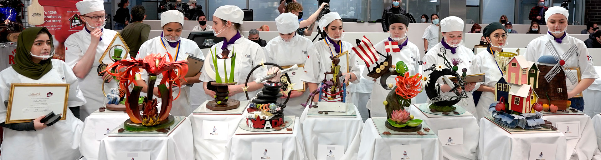 line up of pastry students with their creations at a competition