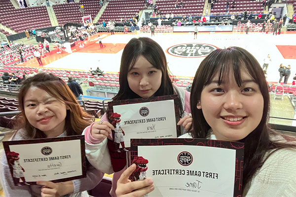 three people taking a selfie while holding certificates