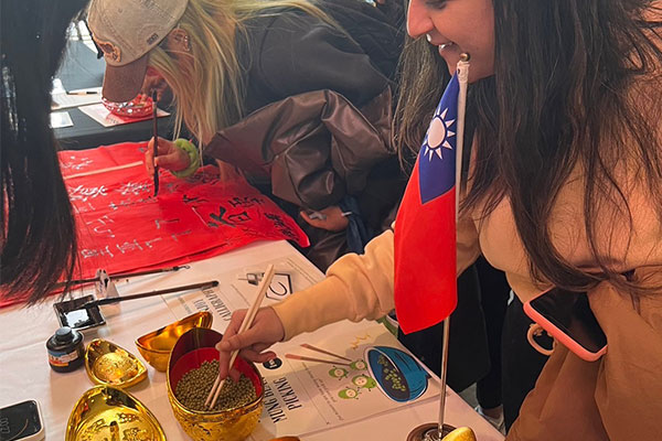 students using chopsticks and writing