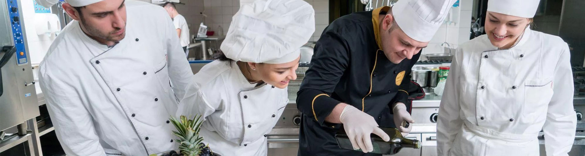 three students watching the head chef