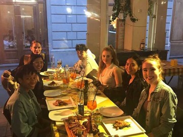 students sitting around a table in a restaurant