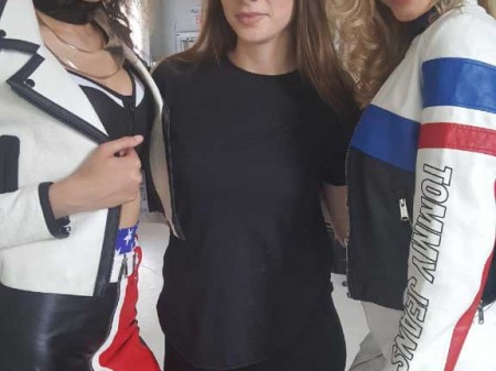 two models posing with students