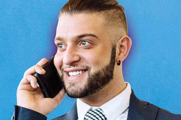 smiling student on the phone on blue background