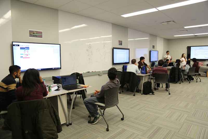 Students on BizCafe simulation software