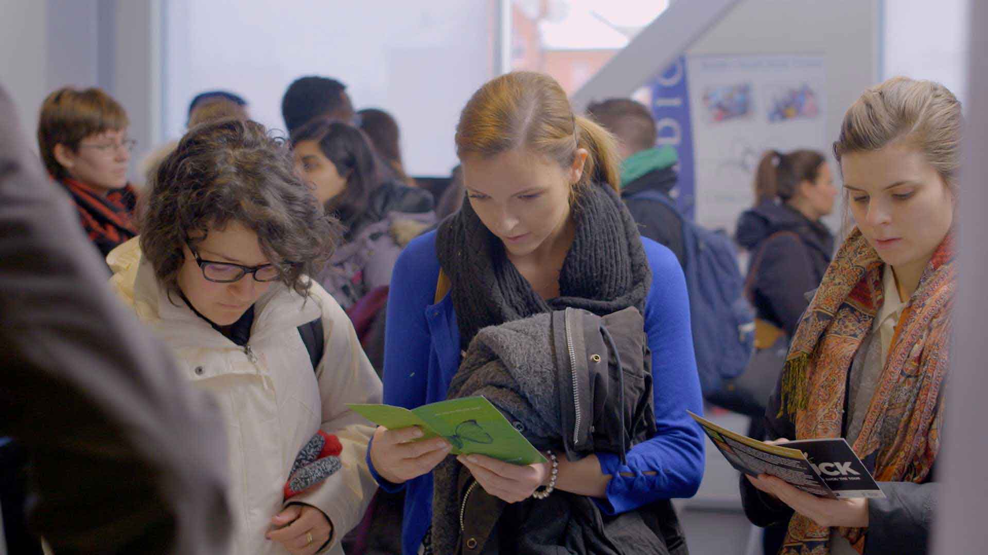 students reading pamphlets
