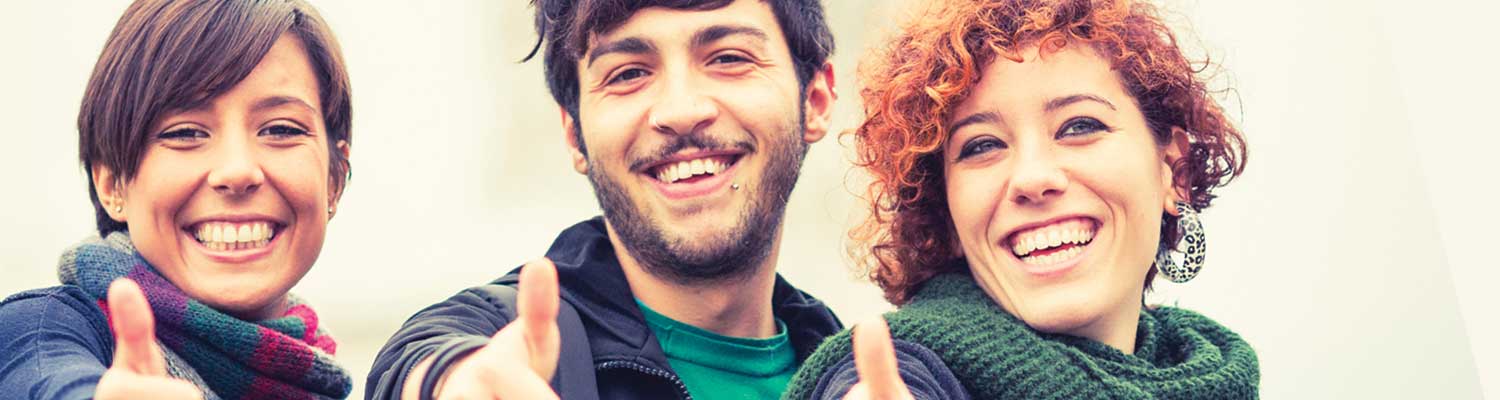 Three students giving a thumbs up