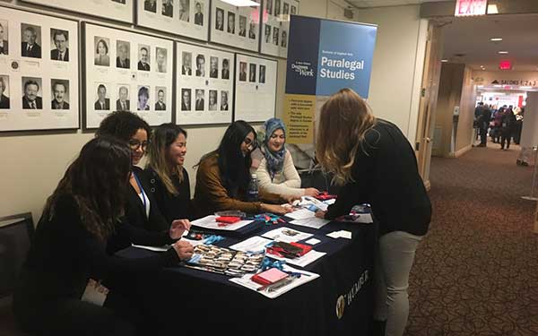 Paralegal students staffing OBE table