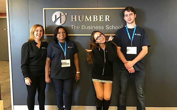 Business Professor and Program Coordinator Maria Racanelli with Business students Lisa, Katerina and Sebastian at the Open House