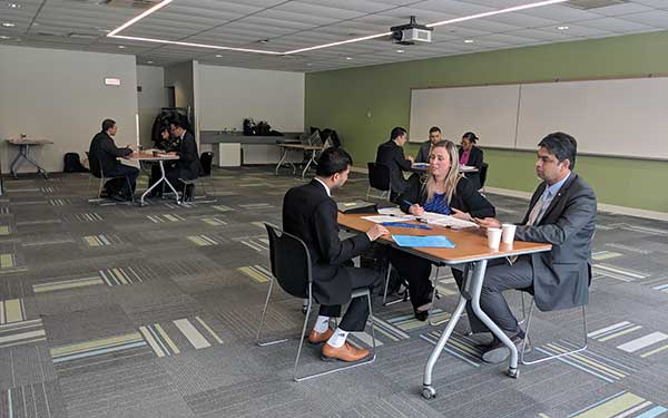 Group of people talking at tables