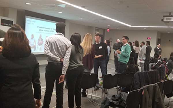 students mingling with each other in conference room