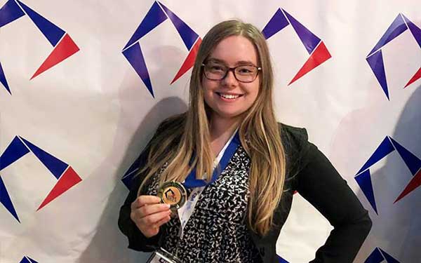 Student with medal at York invitational 