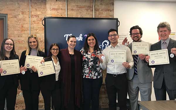 Digital Business Management Graduating Class holding up certificates