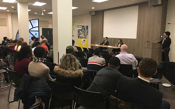 finance students listening to a panel of speakers