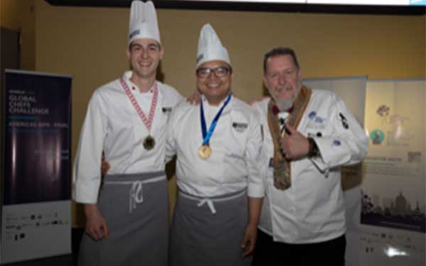 Three chefs wearing medals