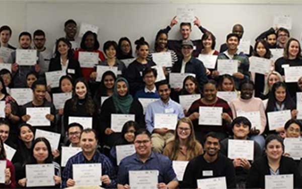 Group of people holding up paper