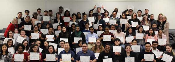 Group of people holding up paper