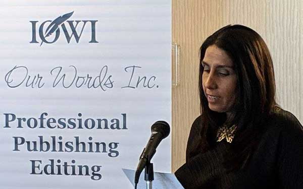 Woman reading from a paper in front of a podium
