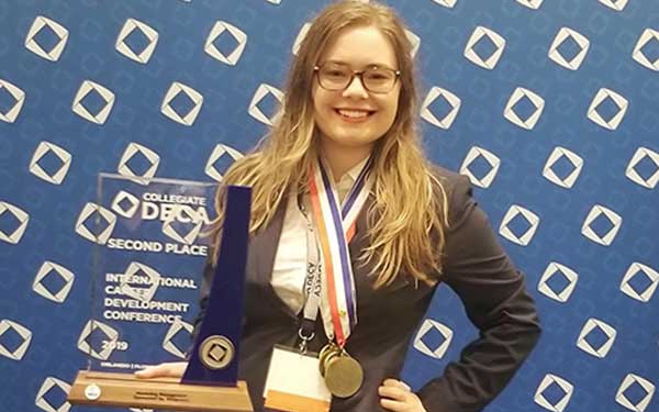 student holding award