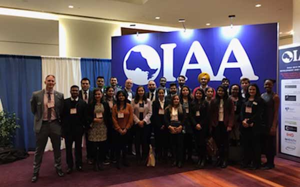 Group of students and professionals posing for photo 