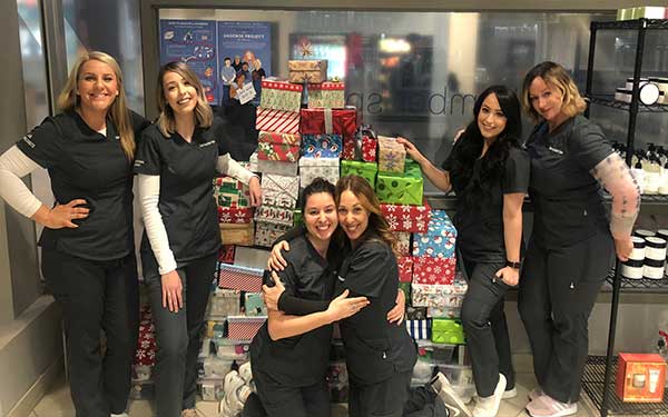 Humber Spa Team gathered around a pile of christmas gifts